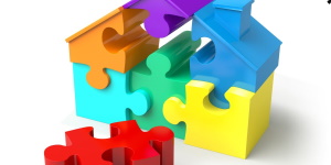 afbeelding huisje bestaande uit gekleurde puzzelstukken
